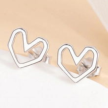 Primo piano di orecchini a lobo a cuore cavo in argento sterling S925 con chiusure