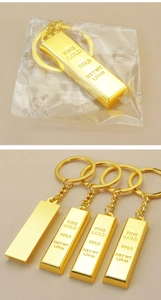 Detail view of gold bar keychains with FINE GOLD 999.9 engraving in OPP bag packaging