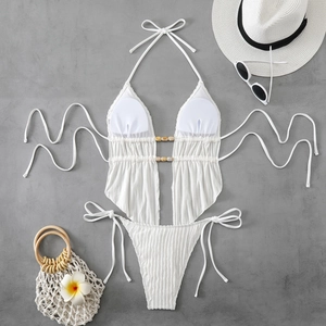 Close-up of white textured monokini fabric with stylish beads and drawstring details