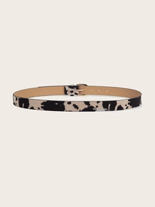 Close-up of animal print calf hair skinny belt featuring a polished gold pin buckle