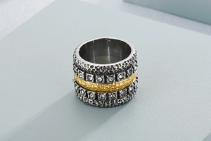 Macro detail of mixed metal stainless steel ring with hammered texture and pave crystals