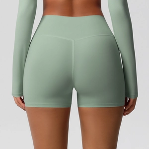 Close-up of high-waisted yoga shorts in pale green with seamless stitching for fitness