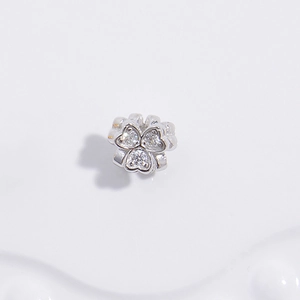Macro view of S925 silver flower charm with shimmering zircons for DIY jewelry
