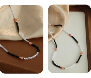 Detail of handcrafted faceted black and sunstone beads with golden metal spacers