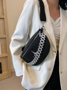 Detail of black lychee grain leather crossbody bag with silver star and chain decor