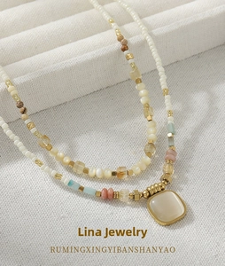 Detailed macro view of colorful natural stone beads and square gemstone pendant necklace