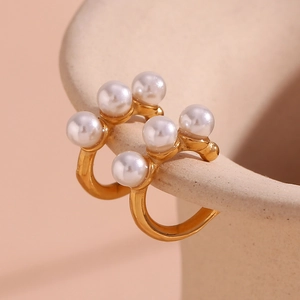 Detailed macro view of 18K gold plated ear cuff featuring three elegant white pearls