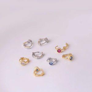 Detail of colorful cubic zirconia hoop earrings in gold and silver finish, set of seven
