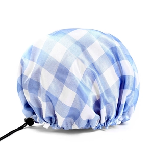 Detail of adjustable elastic drawstring and toggle on blue gingham waterproof shower cap