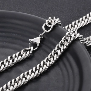 Close-up of polished silver titanium steel curb chain necklace with secure lobster clasp