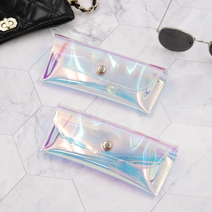 Detail of iridescent PVC eyewear pouches with metal snap button and pearlescent finish