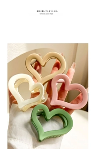 Set of four matte acrylic heart hair claws in cream, beige, pink and green tones