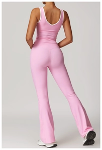 Detail view of pink yoga set with crisscross back design and flared leggings