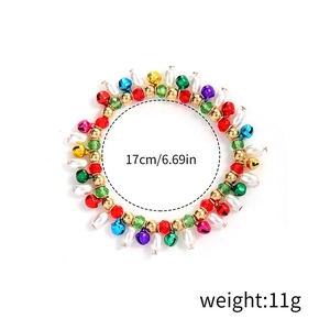 Christmas beaded bracelet with colorful bells, snowflakes and pearls on white background