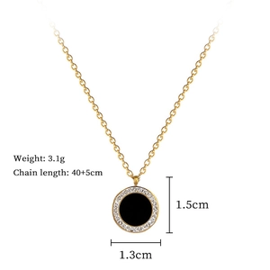 Detail showing gold chain with round black pendant, 1.3cm diameter and 3.1g weight