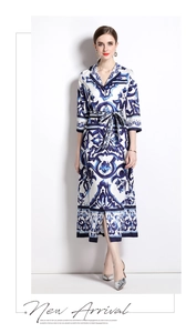 Detail of blue and white majolica print midi dress featuring waist tie and silky fabric