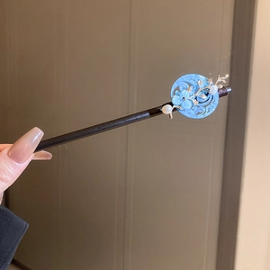 Detail of vintage style hair stick with blue hollow flower, pearl and metal leaf accents