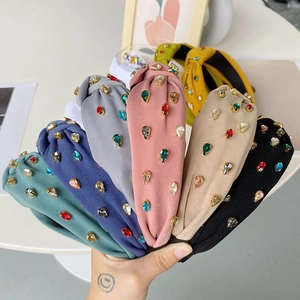Handheld assortment of Baroque knotted headbands with colorful rhinestone embellishments