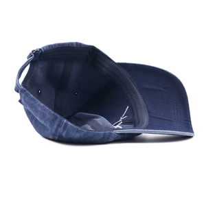 Inside view of vintage washed navy blue baseball cap showing seams and metal buckle strap