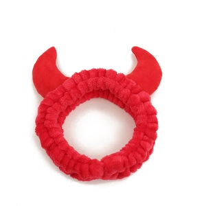 Cute red devil horn plush headband for face washing and makeup on white background