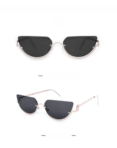 Detail view of cat eye sunglasses with black lenses and rose gold metal frame in C1 style