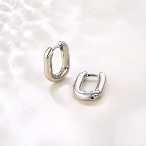 Macro detail of silver U-shaped oval hoop earrings with polished mirror finish and hinge closure