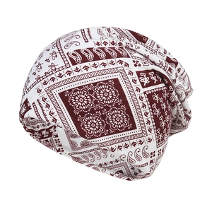 Red paisley print slouchy beanie hat for women featuring ethnic floral patterns on white