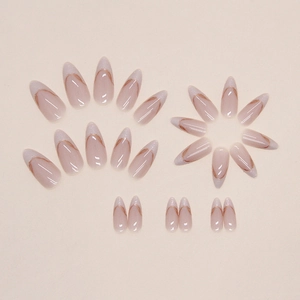 French almond press-on nails with nude pink base, white tips and golden wavy lines