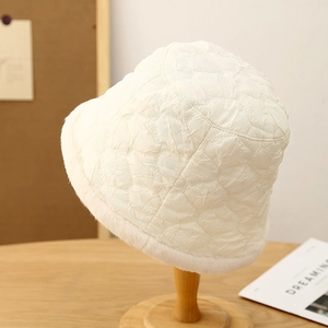 Detail of warm off-white bucket hat featuring pleated texture and soft faux fur trim edge