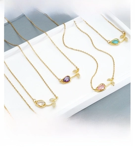Macro detail of tulip pendant necklaces in five colors with gold plating and zircons