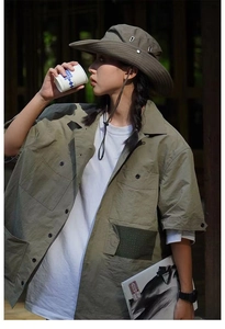 Outdoor sun hat in dark brown worn with cargo shirt for a camping lifestyle look