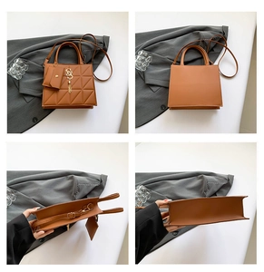 Detail view of brown crossbody bag featuring quilted texture and gold letter charms