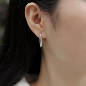 Elegant 925 sterling silver hoop earrings with sparkling zircon on model's ear