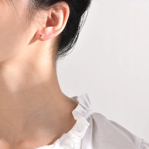 Elegant gold letter Z stud earring with cubic zirconia crystals worn on female earlobe