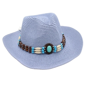 Close-up of blue straw cowboy hat with ethnic beads and a turquoise stone center