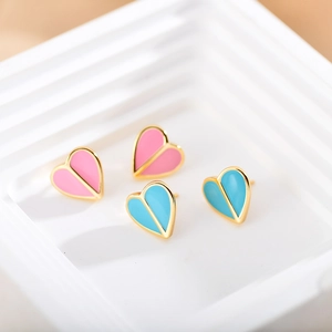 Pink and blue heart-shaped enamel stud earrings with gold borders on a display stand