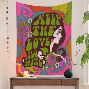 Detail of retro 60s hippie tapestry featuring female profile and Keep The Love Flowing text