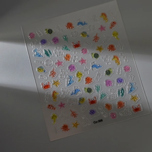 Close-up of 3D marine animal nail stickers featuring colorful crabs and seahorses
