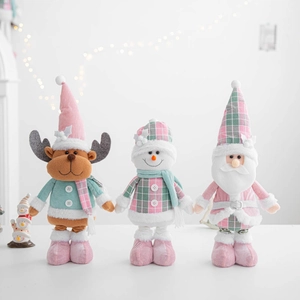 Three plush Christmas figurines in pink and mint green plaid on a clean white surface