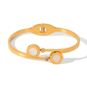 Detail of gold-tone star bracelet with Roman numerals, white shell and zircon inlay