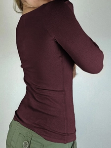 Detail shot of the back view of a slim-fit burgundy long sleeve button-up t-shirt