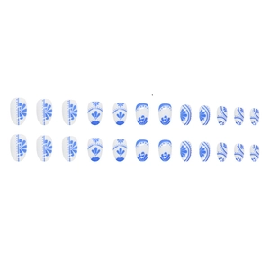 Set of 24 oval press-on nails featuring elegant blue and white porcelain floral patterns