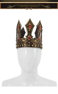 Detail view of retro bronze king crown with intricate hollow carvings and red rhinestones