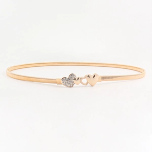 Detail showing golden elastic spring belt with rhinestone studded heart buckle design