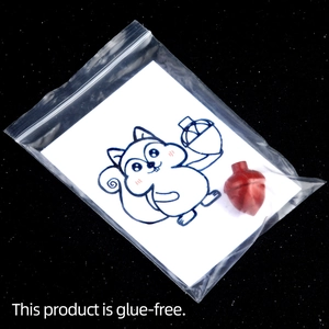 Red pinecone-shaped natural crystal agate stone with creative squirrel card in a sealed bag