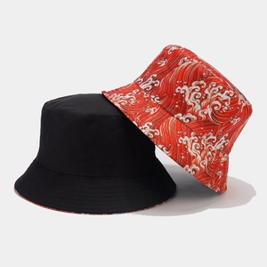 Fashionable reversible bucket hats in solid black and red wave print for sun protection