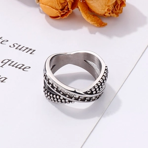 Macro detail of silver twisted ring featuring metal beads and shimmering cubic zirconia
