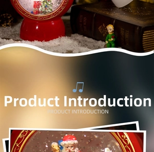 Detail of a Christmas snow globe music box with Santa Claus and golden scroll base
