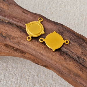 Macro view of gold 304 stainless steel double loop jewelry connector on wood