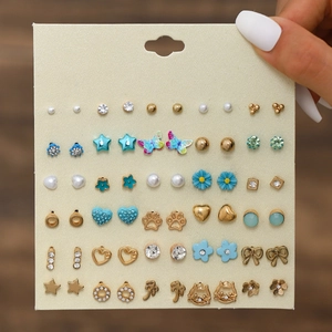 Detail showing 30 pairs of assorted stud earrings with butterfly and floral designs